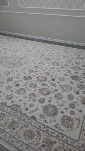 a carpet with a floral pattern on a floor at Elsar guesthouse in Nariman
