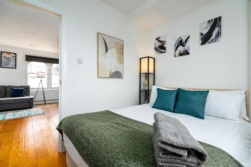 a bedroom with a bed and a living room at West Hampstead Hub in London