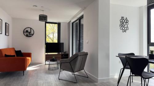 a living room with a table and chairs at Luxury Apartment by Noire Property in Manchester