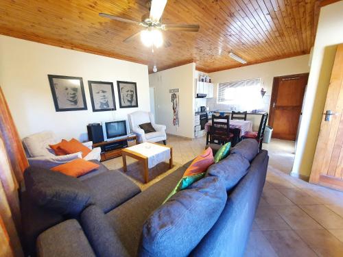 a living room with a large blue couch and a living room at Du Preez Properties in Hentiesbaai