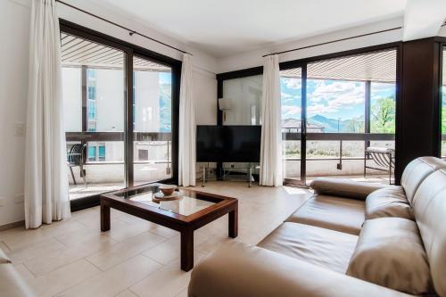 a living room with a couch and a table at The Central Home by Quokka 360 - Next to Lido di Lugano in Lugano