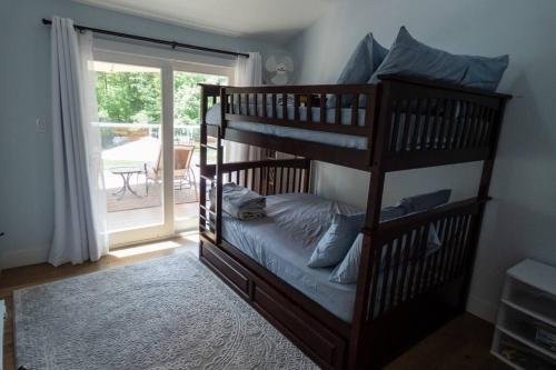 two bunk beds in a room with a balcony at Sun Drenched Lakefront Cove in Monticello
