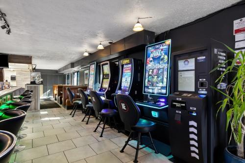 a row of arcade games in a room with chairs at Americas Best Value Inn - Lincoln Airport in Lincoln