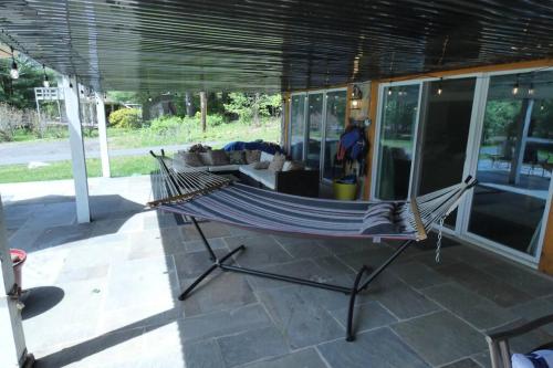 a hammock sitting on a patio in a house at Sun Drenched Lakefront Cove in Monticello