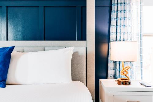 a bedroom with a bed with a blue wall at Salem Waterfront Hotel & Suites in Salem