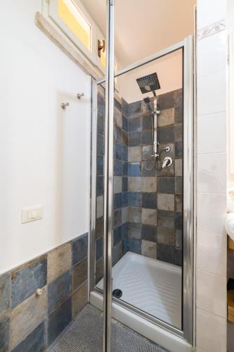 a shower with a glass door in a bathroom at bilocale centro storico Cesena Casa Ludo in Cesena