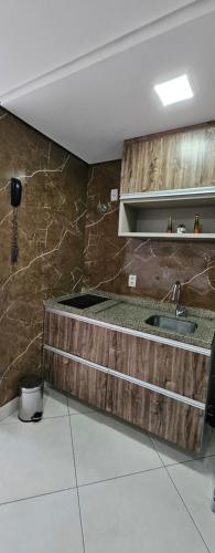 a kitchen with a wooden counter and a sink at Landscape Apartment TC1502 in Fortaleza