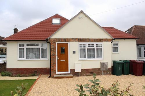 a white house with a red roof at Westleigh House in Fishbourne