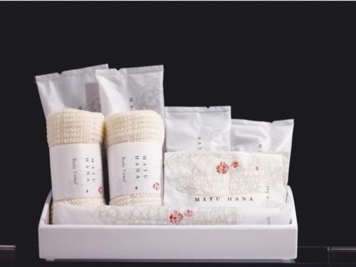 a white box filled with white towels and other towels at AIRAIKUHOTEL kagoshima in Aira