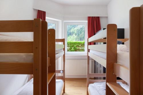 a dorm room with bunk beds and a window at Apartment Tux in Mayrhofen