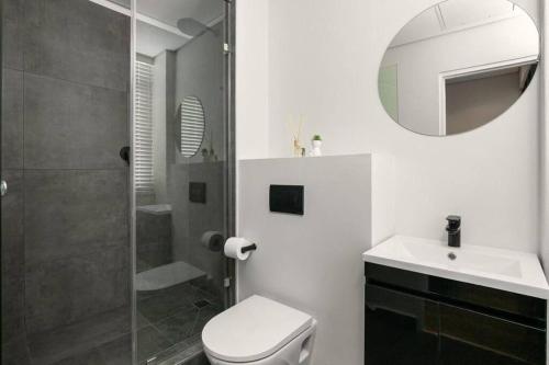 a bathroom with a toilet and a sink and a shower at Hotel Apt, Wifi, Roof Deck, Central CBD, 247 Power in Cape Town