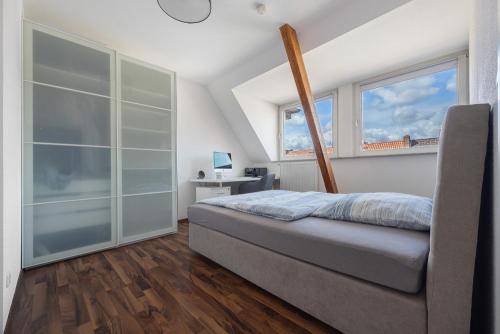 a bedroom with a bed and two windows at Haus Hannover in Hannover