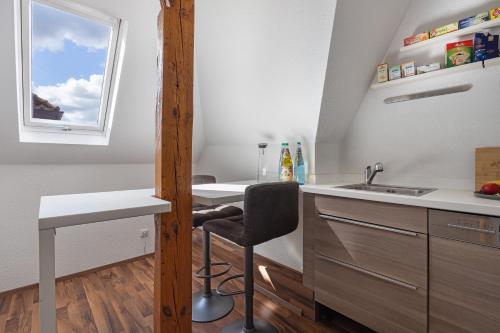 a kitchen with a sink and a desk and a window at Haus Hannover in Hannover