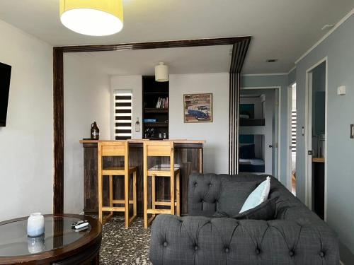 a living room with a couch and a table at Casa Entre Glaciares in Puerto Natales