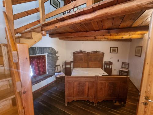 an attic room with a bed and a staircase at La mine d'Antan in Ollomont