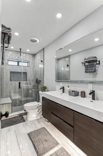 a bathroom with a sink and a toilet and a shower at Miami Oasis, Spacious 4-Bedroom Home with Pool in Miami