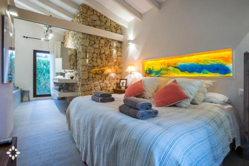 a bedroom with a large bed with towels on it at Villa Barbados by Abahana Luxe in Benissa