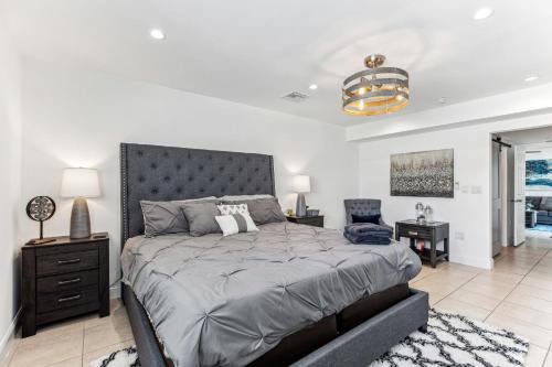 a bedroom with a large bed and a chair at Miami Oasis, Spacious 4-Bedroom Home with Pool in Miami