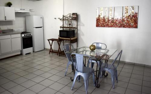 a kitchen with a glass table and chairs in it at Group Unit Great Location in San Juan