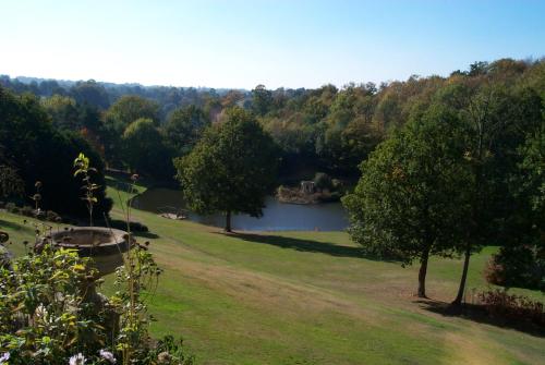 a view of a park with a lake and trees at Accommodation at Salomons Estate in Royal Tunbridge Wells