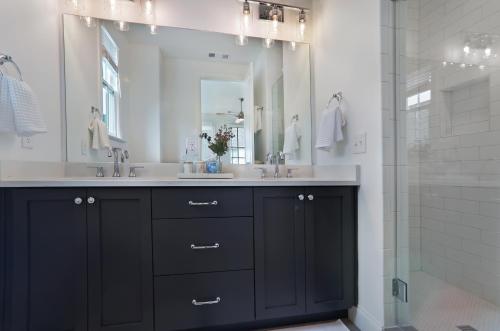 a bathroom with a black vanity and a mirror at Hedge Haus in Atlanta