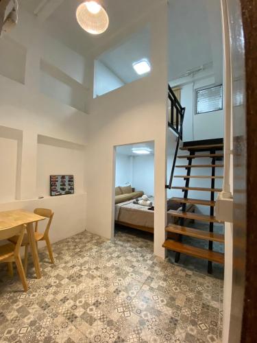 a living room with a staircase and a bedroom at @888byChefKong in Koh Tao