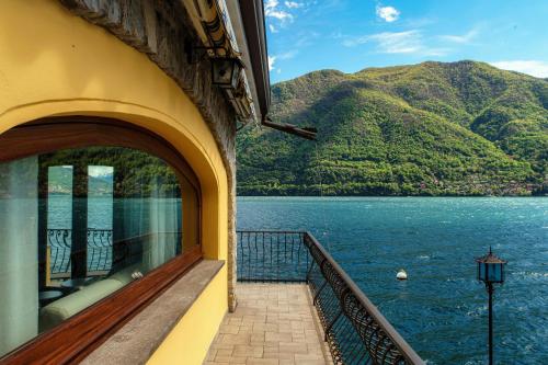 a balcony of a building with a view of a lake at Darsena Brienno by Quokka 360 - Access to lake in Brienno