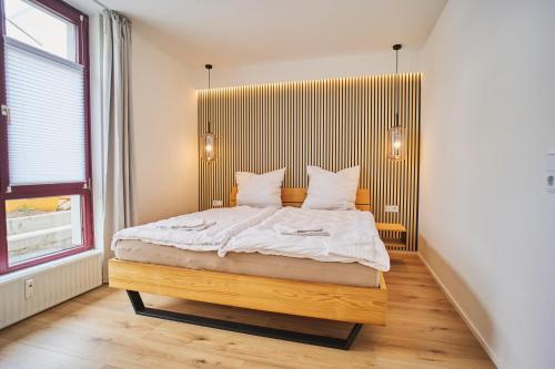 a bedroom with a large bed with a wooden headboard at City-Deluxe in Braunschweig in Braunschweig