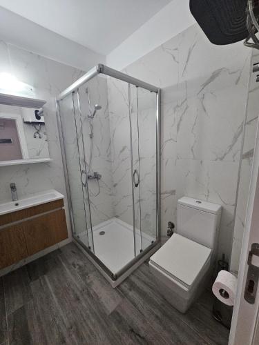 a bathroom with a shower and a toilet at Caesar Blue Resort Studio with Sea View in Trikomo