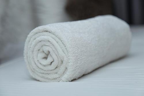 a roll of white towels sitting on a table at Kandy Tower Inn in Kandy