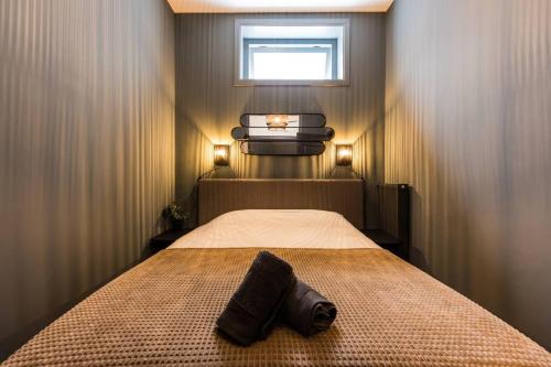 een slaapkamer met een bed met een handdoek erop bij Apartment Viognier in Den Haag