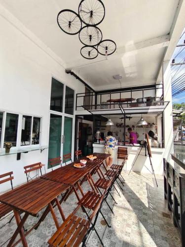 a patio with a long wooden table and benches at @888byChefKong in Koh Tao