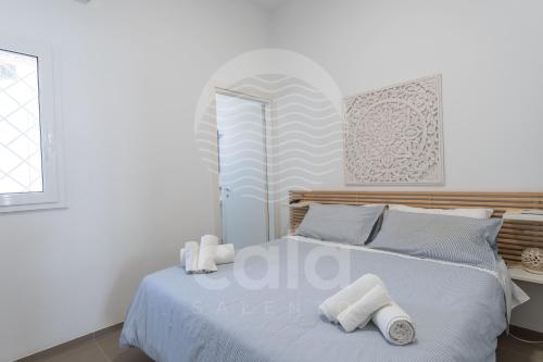 una camera da letto con un letto con asciugamani sopra di Villa Giulia By Cala Salento a Torre Lapillo