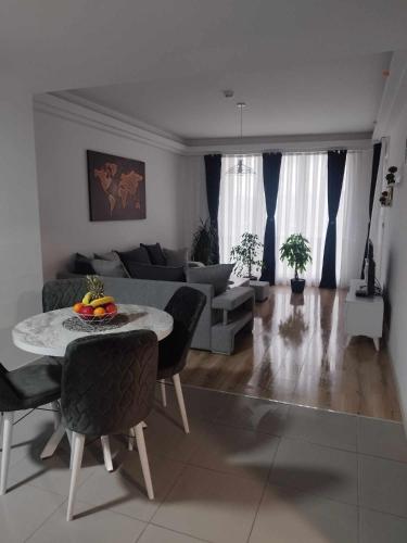 a living room with a table and a couch at Skopje Sky Apartments & Floor 33th 28th & 25th & 19th & 13th 12th With Pool & Spa & Fitness & Parking Included in Price in Skopje