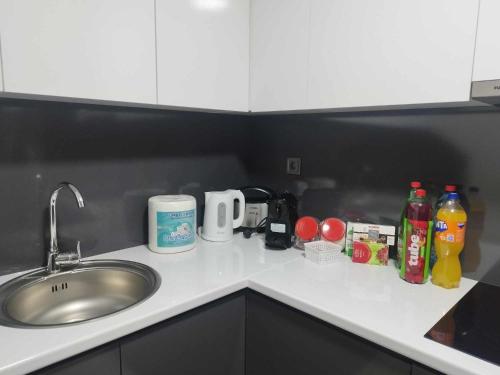 a kitchen counter top with a sink and a counter top at Skopje Sky City 19th Floor Twin Apartments with Indoor Pool & Spa & Fitness Including in Price in Skopje