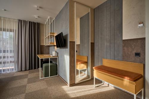 a hotel room with a bed and a desk at Hotel Vedmezhyi Dvir in Bukovel