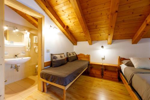 a bedroom with a bed and a sink in a room at B&B Seppi in Cavalese