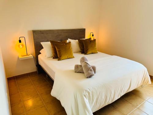 a bedroom with a large white bed with two pillows at Villa Chayofa in Chayofa