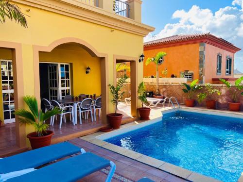 a house with a swimming pool and a patio at Villa Chayofa in Chayofa