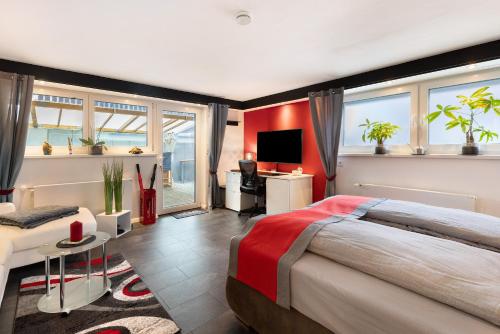 a bedroom with a large bed and a living room at Apartment Am Tobelbach in Oberlenningen