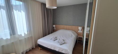 une chambre avec un lit avec deux serviettes dessus dans l'établissement Hôtel Beaurivage, à Agon-Coutainville