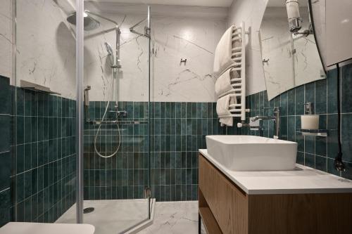 a bathroom with a sink and a shower at Hotel Vedmezhyi Dvir in Bukovel