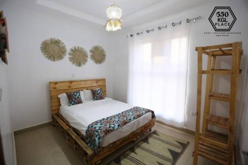 a bedroom with a bed and a wooden ladder at Style and Comfort Full Kigali Rwanda Apartment in Kigali