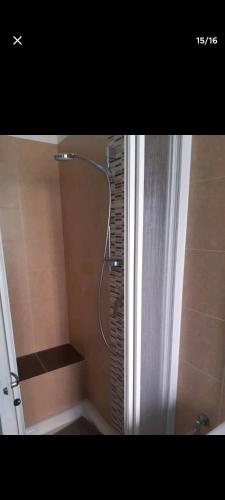 um chuveiro na casa de banho com uma cortina de chuveiro em A due passi dal mare. em Falconara Marittima