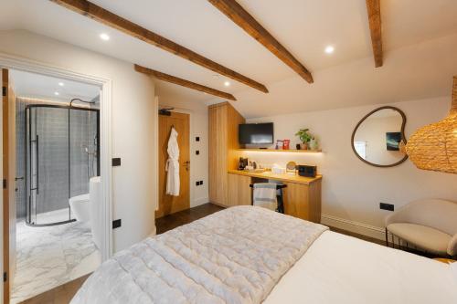 a bedroom with a large bed and a bathroom at Hive Townhouse in Aberaeron