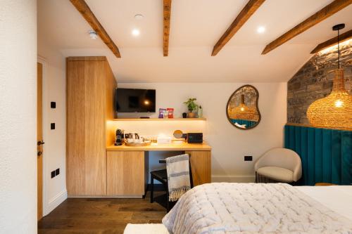 a bedroom with a bed and a desk in a room at Hive Townhouse in Aberaeron