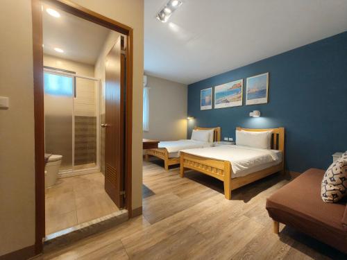 a hotel room with two beds and a bathroom at Water World Diving Resort in Green Island
