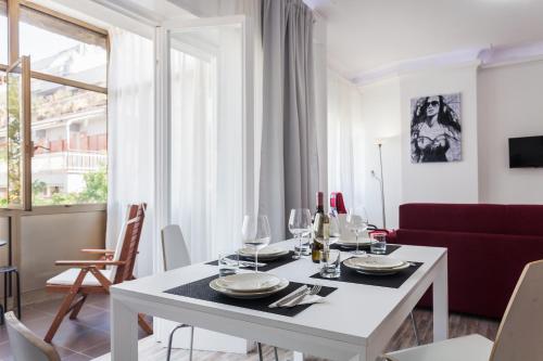 a white dining room with a white table and chairs at St Peter Lodge in Rome