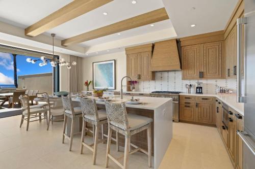 a kitchen with wooden cabinets and a table and chairs at Timbers 3003 condo in Lihue