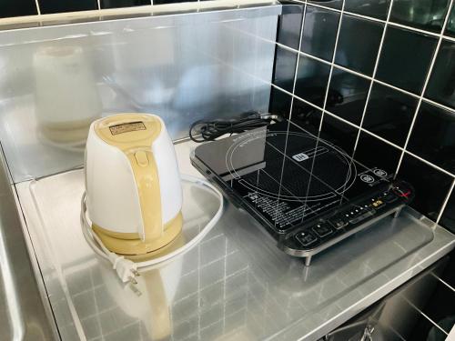 a hair dryer sitting on a shelf in a refrigerator at Warm House2 in Sapporo